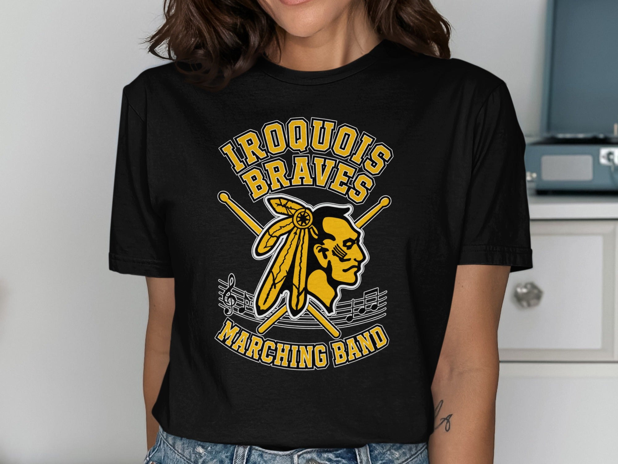 Iroquois Braves Marching Band logo with drumsticks and musical notes.