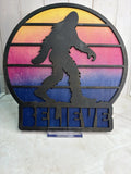 RJ Custom Works Bigfoot silhouette with sunset gradient and BELIEVE text