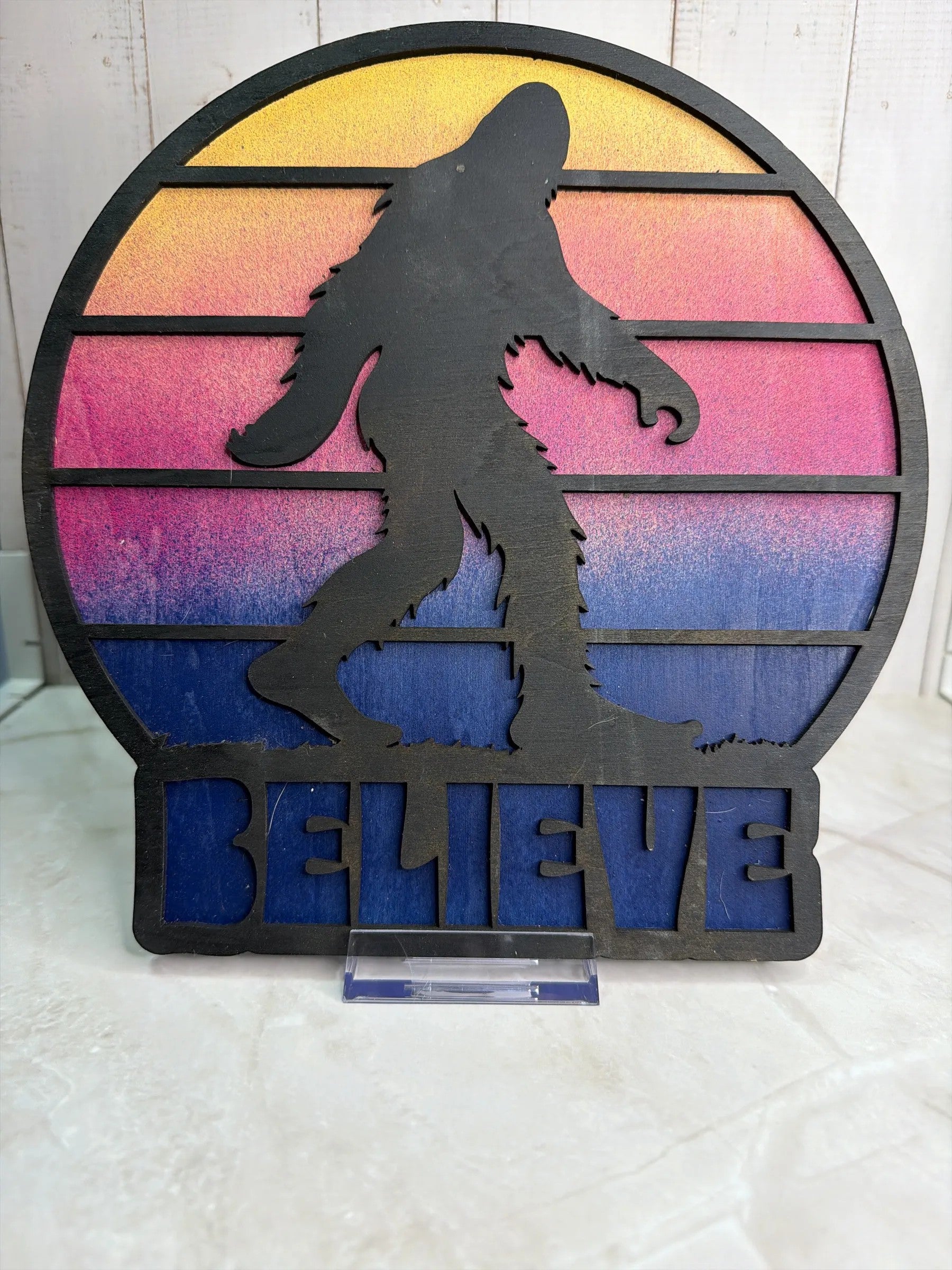 RJ Custom Works Bigfoot silhouette with sunset gradient and BELIEVE text