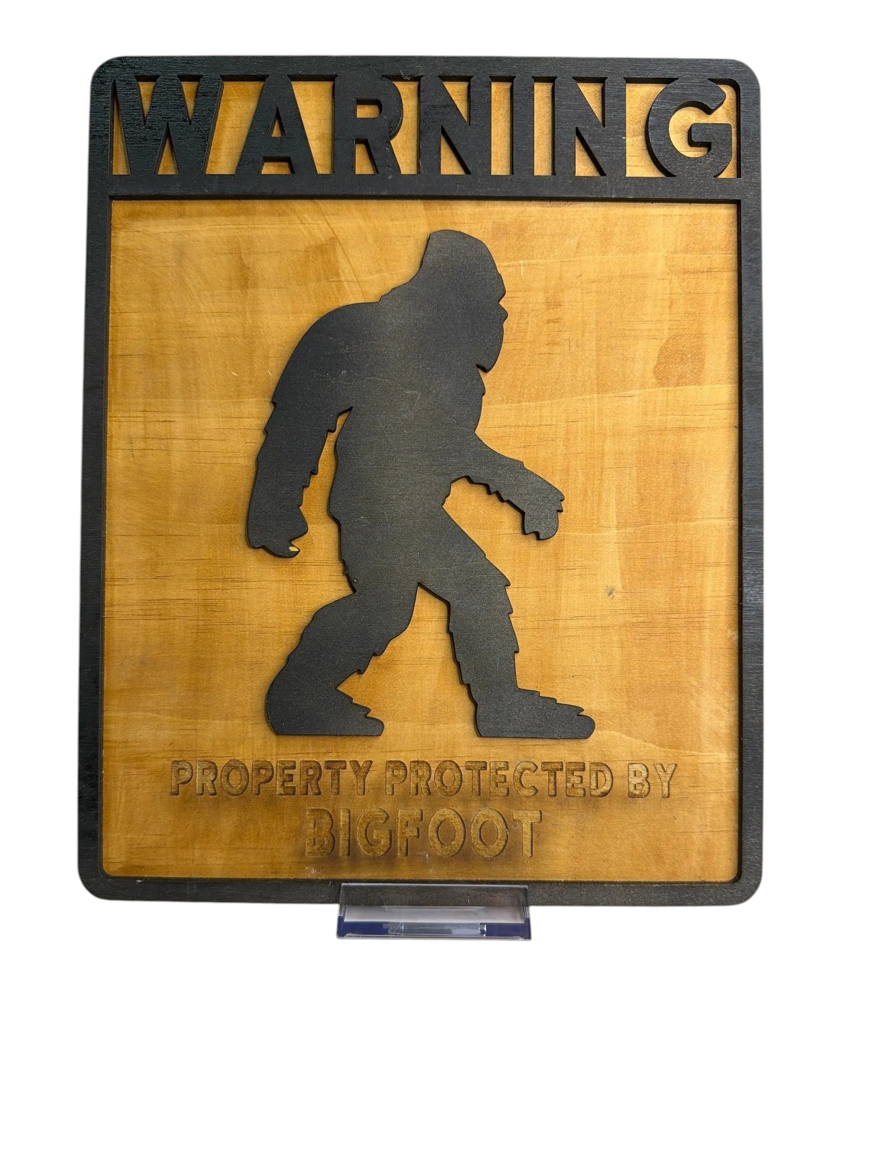 RJ Custom Works wooden sign with black Bigfoot silhouette and "WARNING PROPERTY PROTECTED BY BIGFOOT" text.