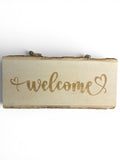 RJ Custom Works live edge wood welcome sign with a heart detail. Natural wood finish.