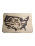 RJ Custom Works patriotic bamboo cutting board featuring an eagle head superimposed on a USA map with the American flag design.